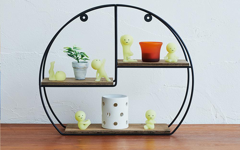 smiski yoga series lineup on a shelf setup with fake plant props